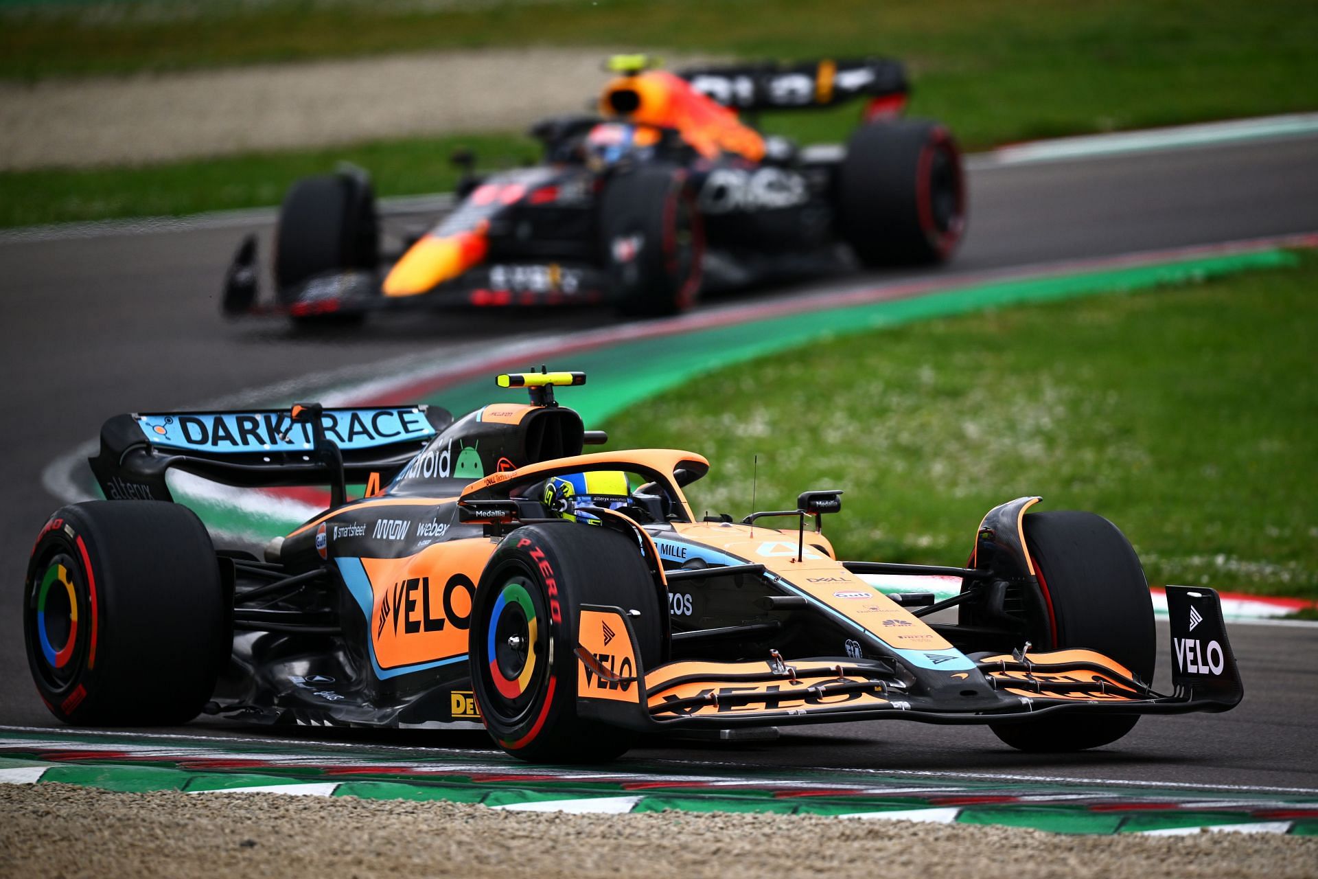 Lando Norris (4) McLaren MCL35 ahead of Sergio Perez (11) Red Bull Racing RB18