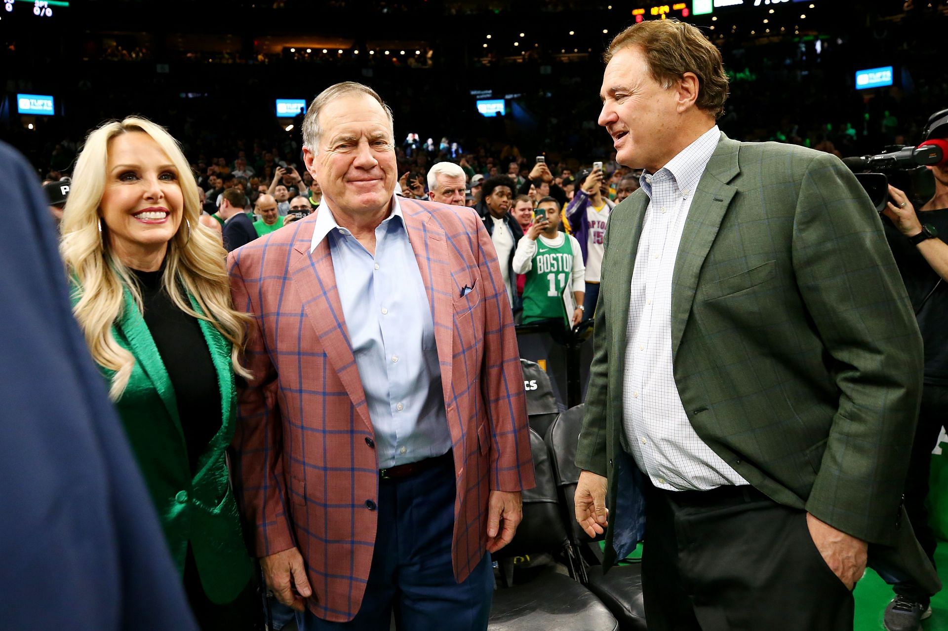 BOSTON, MASSACHUSETTS - FEBRUARY 07: From left, Linda Holliday, New England Patriots head coach Bill Belichick, and Celtics co-owner Stephen Pagliuca talk before the game between the Boston Celtics and the Los Angeles Lakers at TD Garden on February 07, 2019 in Boston, Massachusetts.