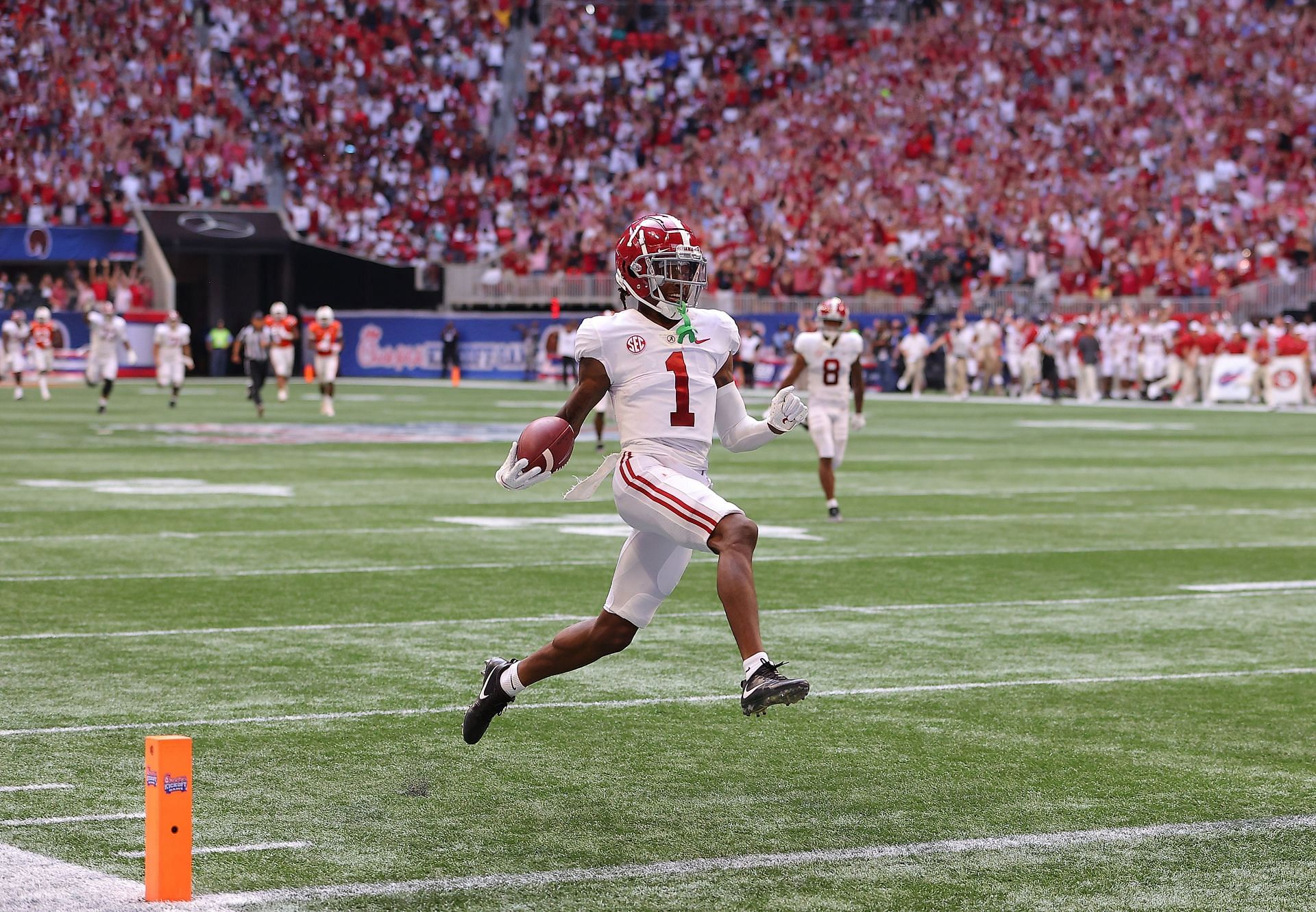 Jameson Williams #1 of the Alabama Crimson Tide reacts as he takes this long reception for a touchdown against the Miami Hurricanes during the second half of the Chick-fil-A Kick-Off Game at Mercedes-Benz Stadium on September 04, 2021 in Atlanta, Georgia.