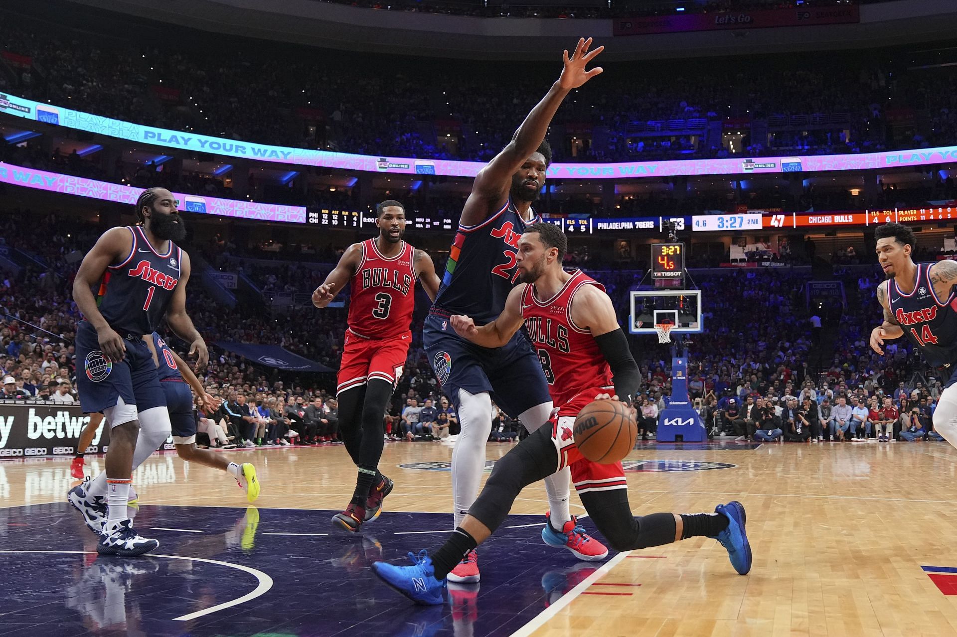 Zach LaVine #8 of the Chicago Bulls dribbles the ball to the basket against Joel Embiid #21 of the Philadelphia 76ers in the first half at the Wells Fargo Center on March 7, 2022 in Philadelphia, Pennsylvania.