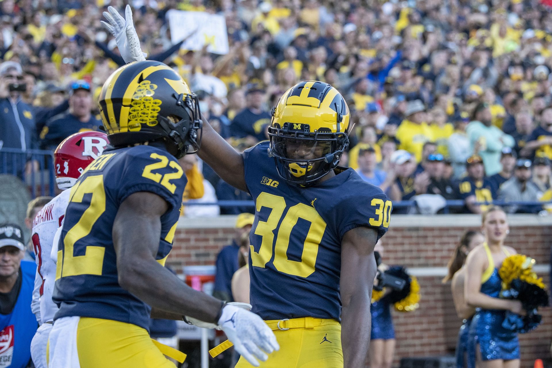 Defensive back Daxton Hill #30 and defensive back Gemon Green #22 of the Michigan Wolverines celebrate breaking up a pass against the Rutgers Scarlet Knights in the third quarter at Michigan Stadium on September 25, 2021 in Ann Arbor, Michigan.