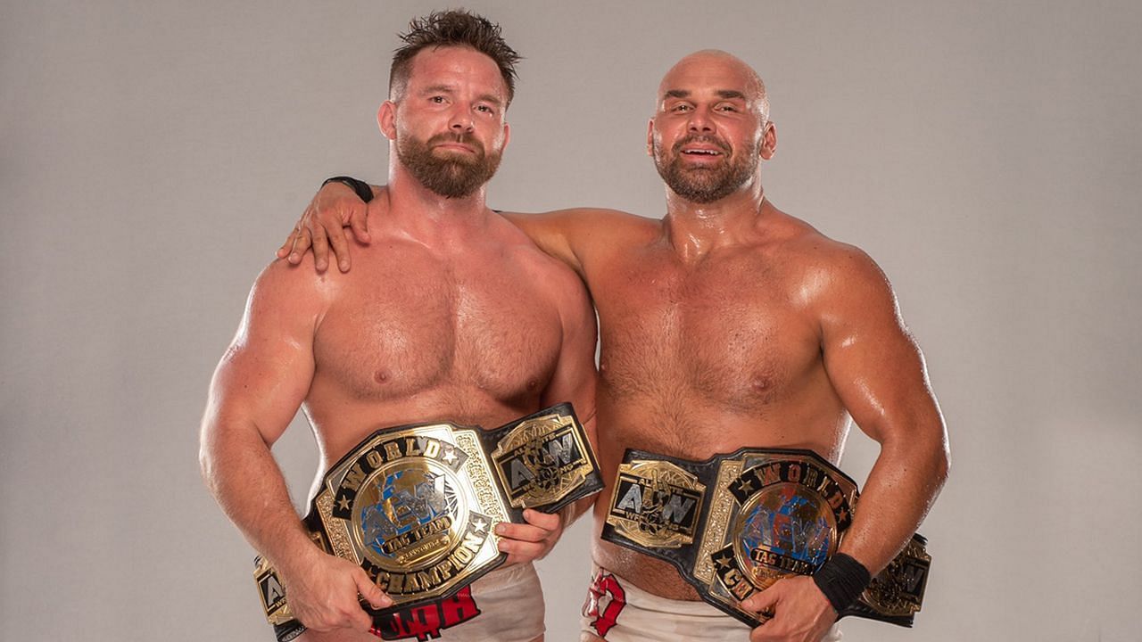 FTR holding their AEW Tag Team Championships.