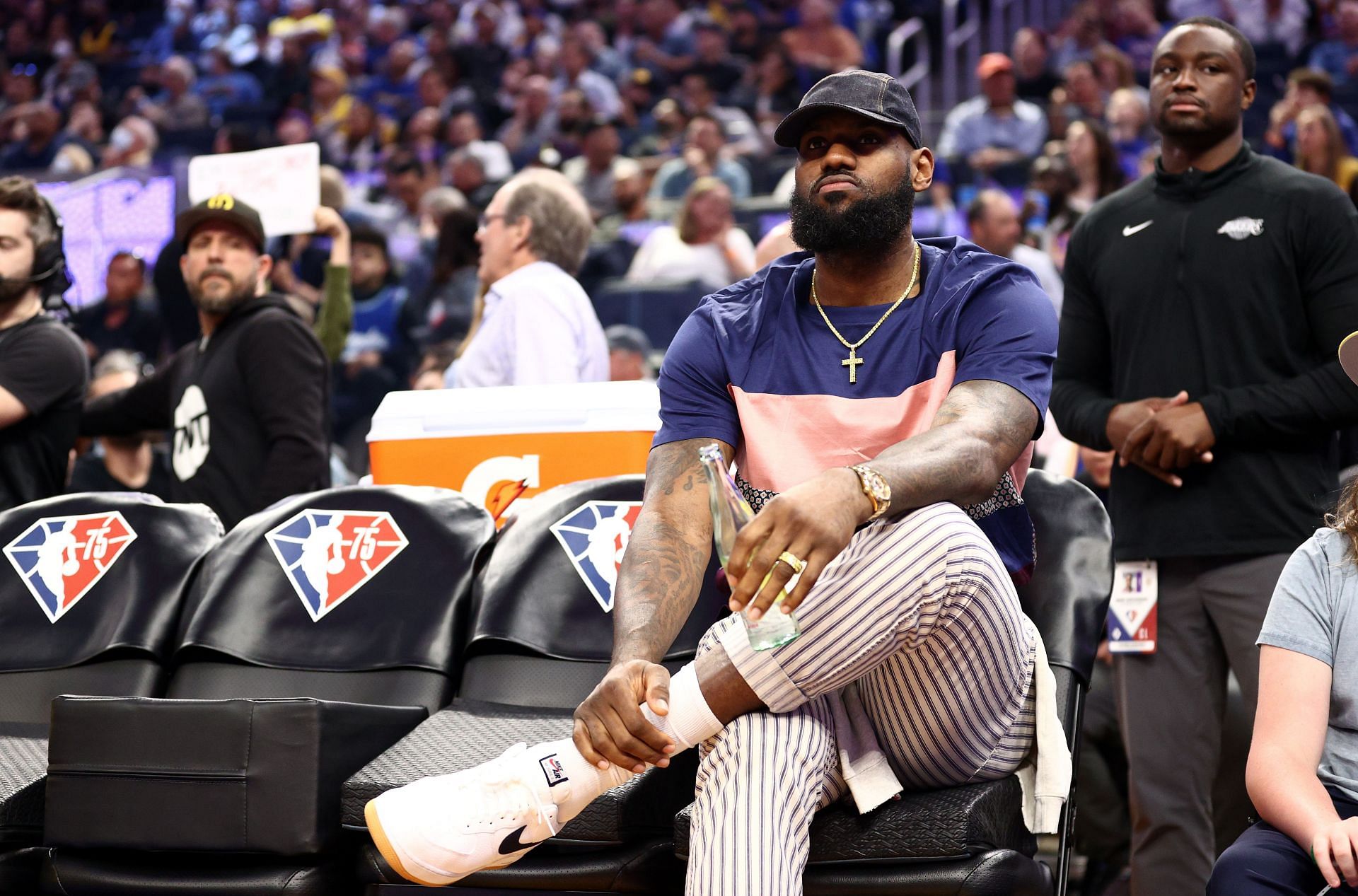 Injured LeBron James #6 of the Los Angeles Lakers sits on the bench during their game Golden State Warriors in the first half at Chase Center on April 07, 2022 in San Francisco, California.
