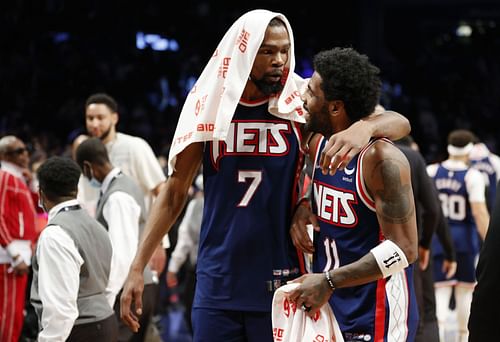 Kevin Durant #7 reacts with Kyrie Irving #11 of the Brooklyn Nets after the second half against the Cleveland Cavaliers at Barclays Center on April 08, 2022 in the Brooklyn borough of New York City. The Nets won 118-107.