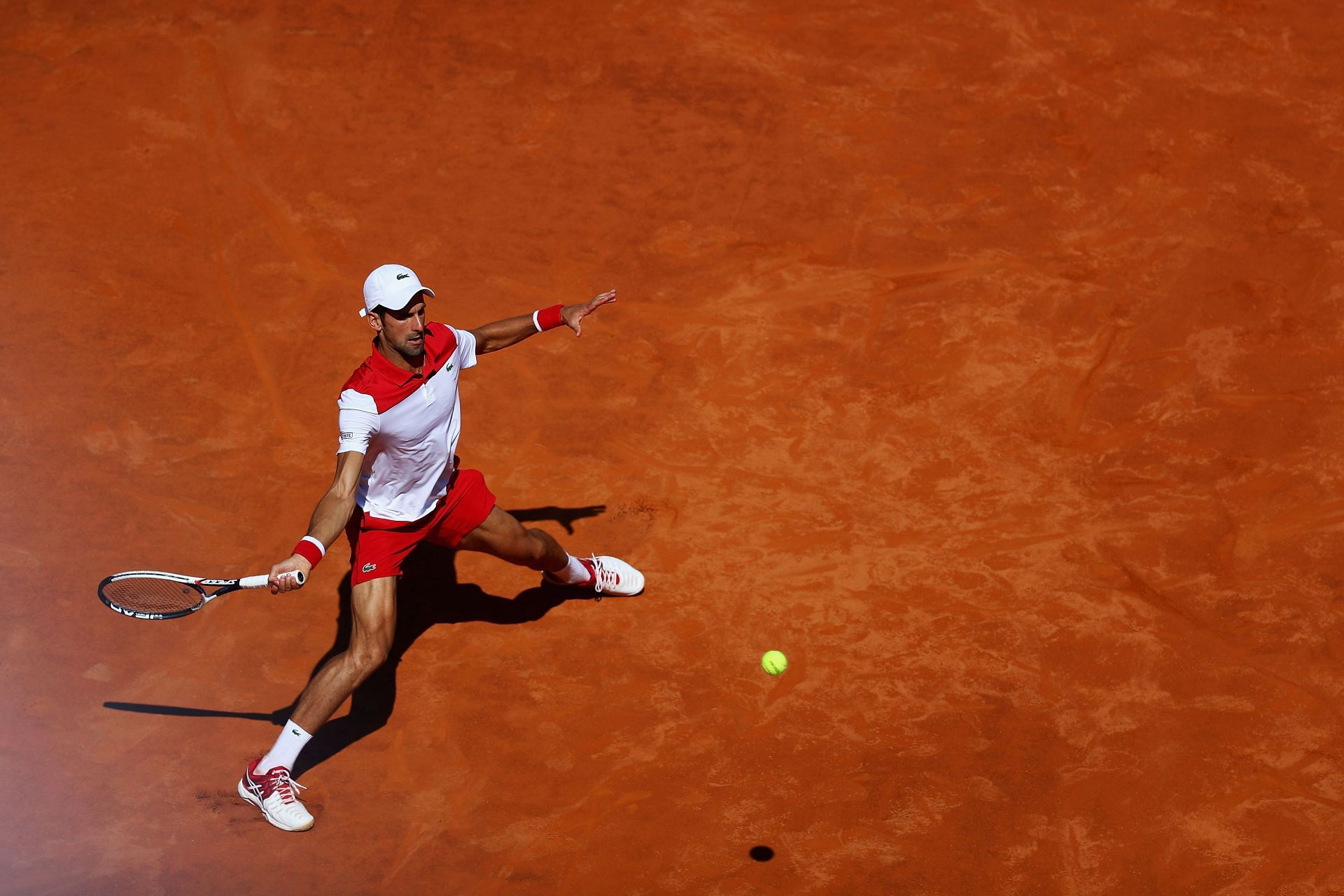 The Serb stretches to make a return on clay