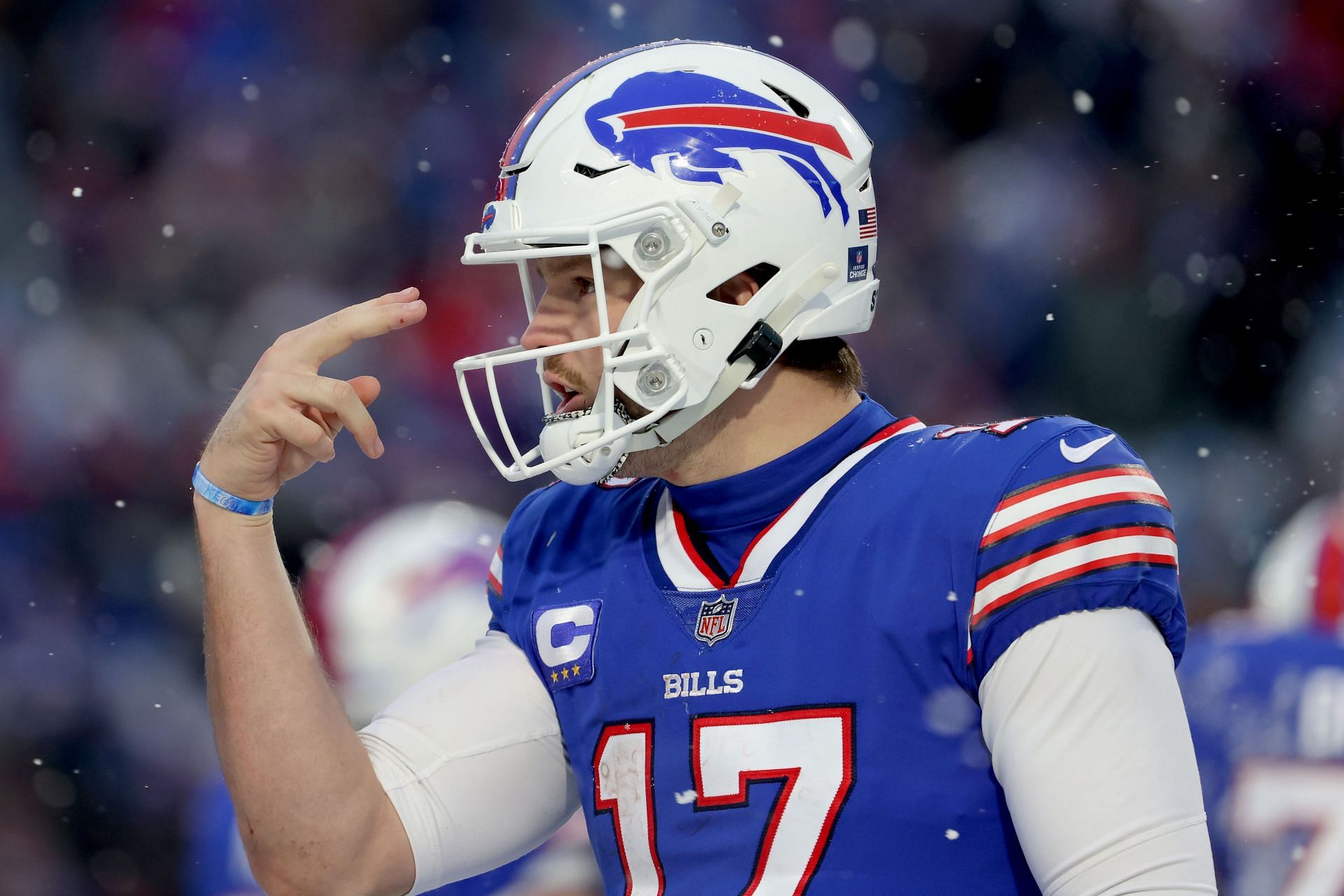 Buffalo Bills RB James Cook attempts to paint team logo with other