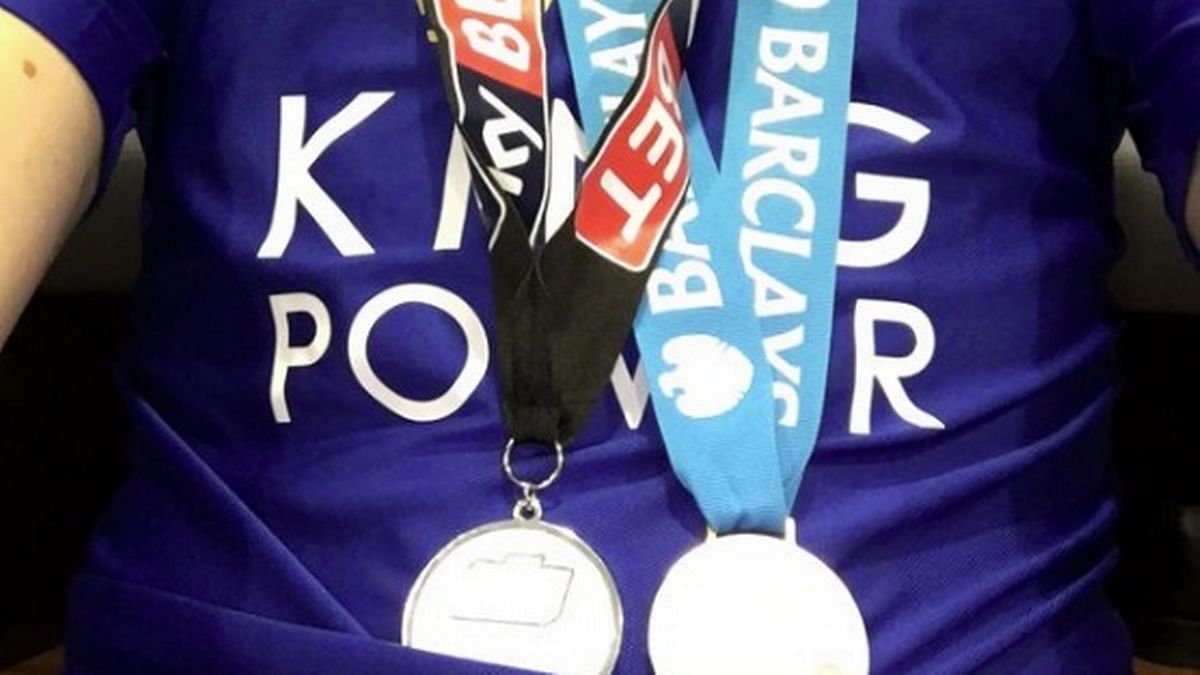 De Laet showing off his two medals from two divisions - a very unique football record
