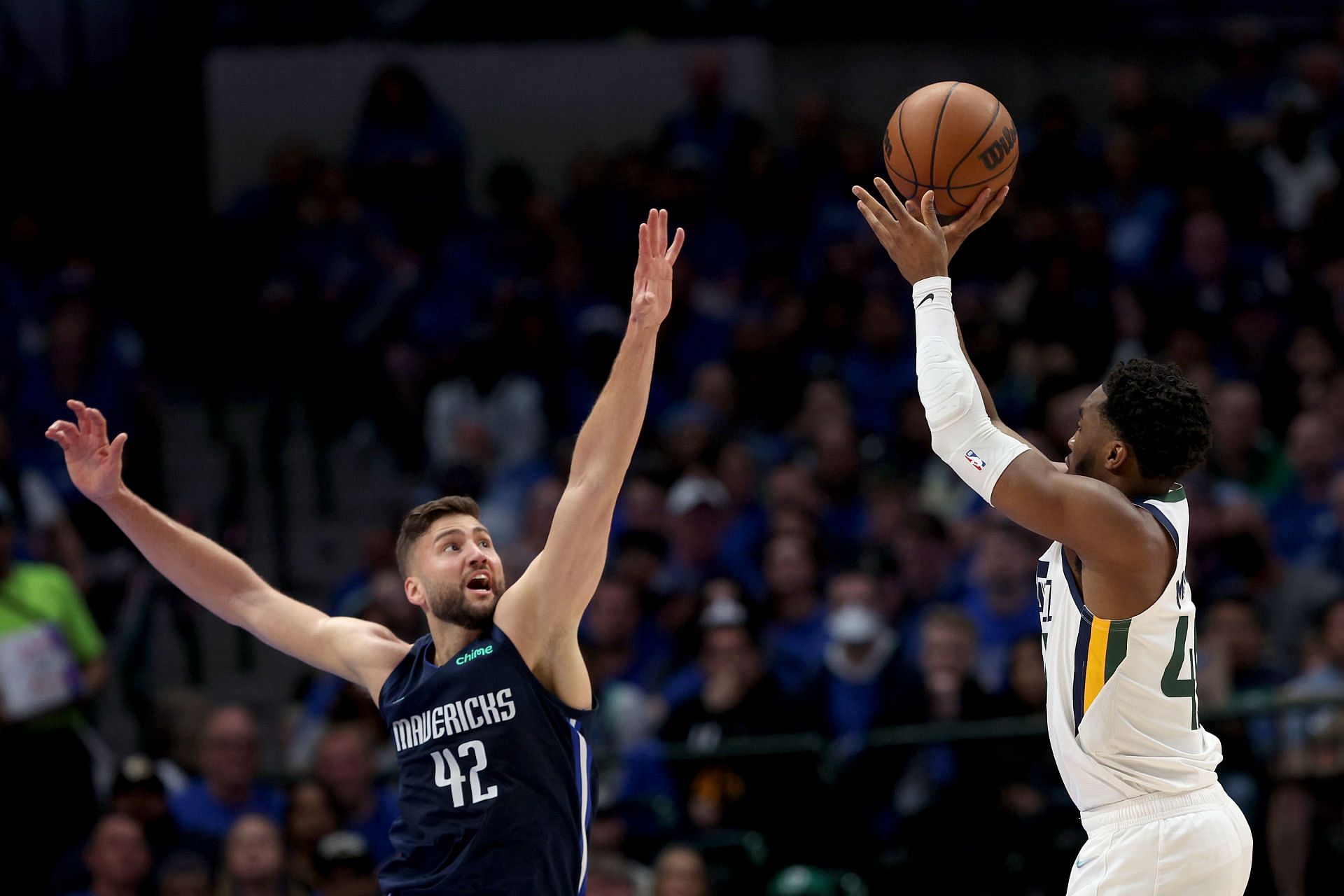 Donovan Mitchell attempts a jump shot over Maxi Kleber