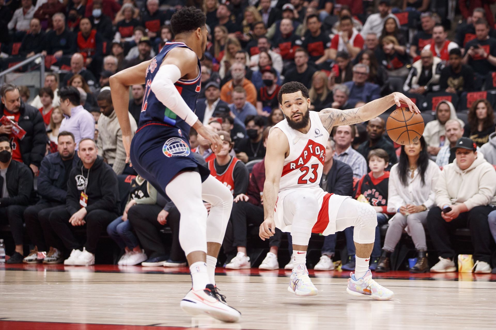 Fred VanVleet #23 of the Toronto Raptors dribbles against Tobias Harris #12 of the Philadelphia 76ers