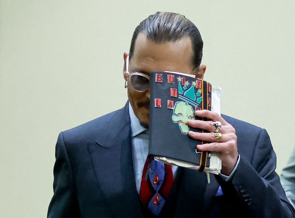 Johnny Depp with his little black sketching book (Image via AFP)