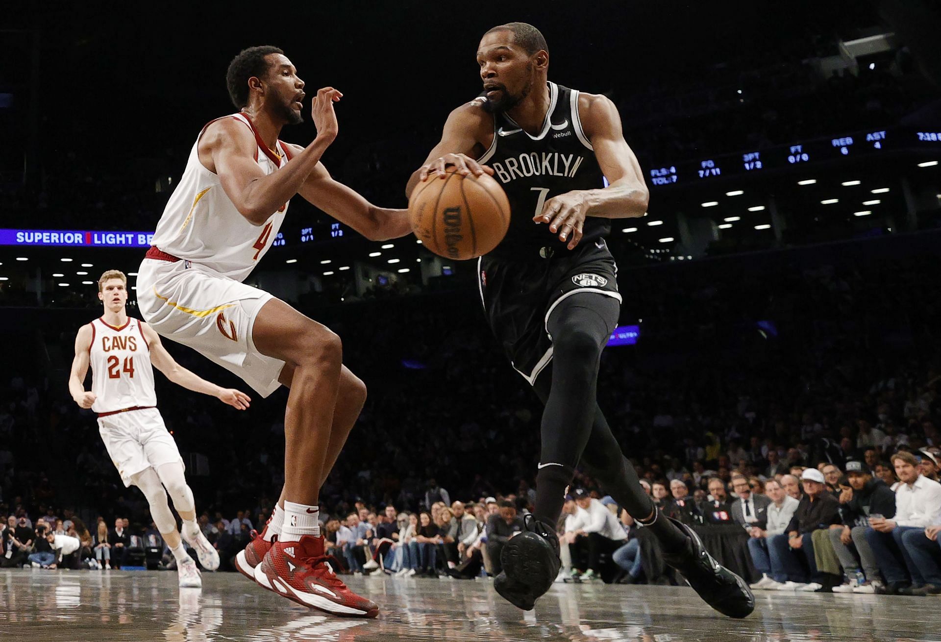 Durant of the Brooklyn Nets dribbles against Evan Mobley No. 4 of the Cleveland Cavaliers during the Eastern Conference 2022 Play-In Tournament.