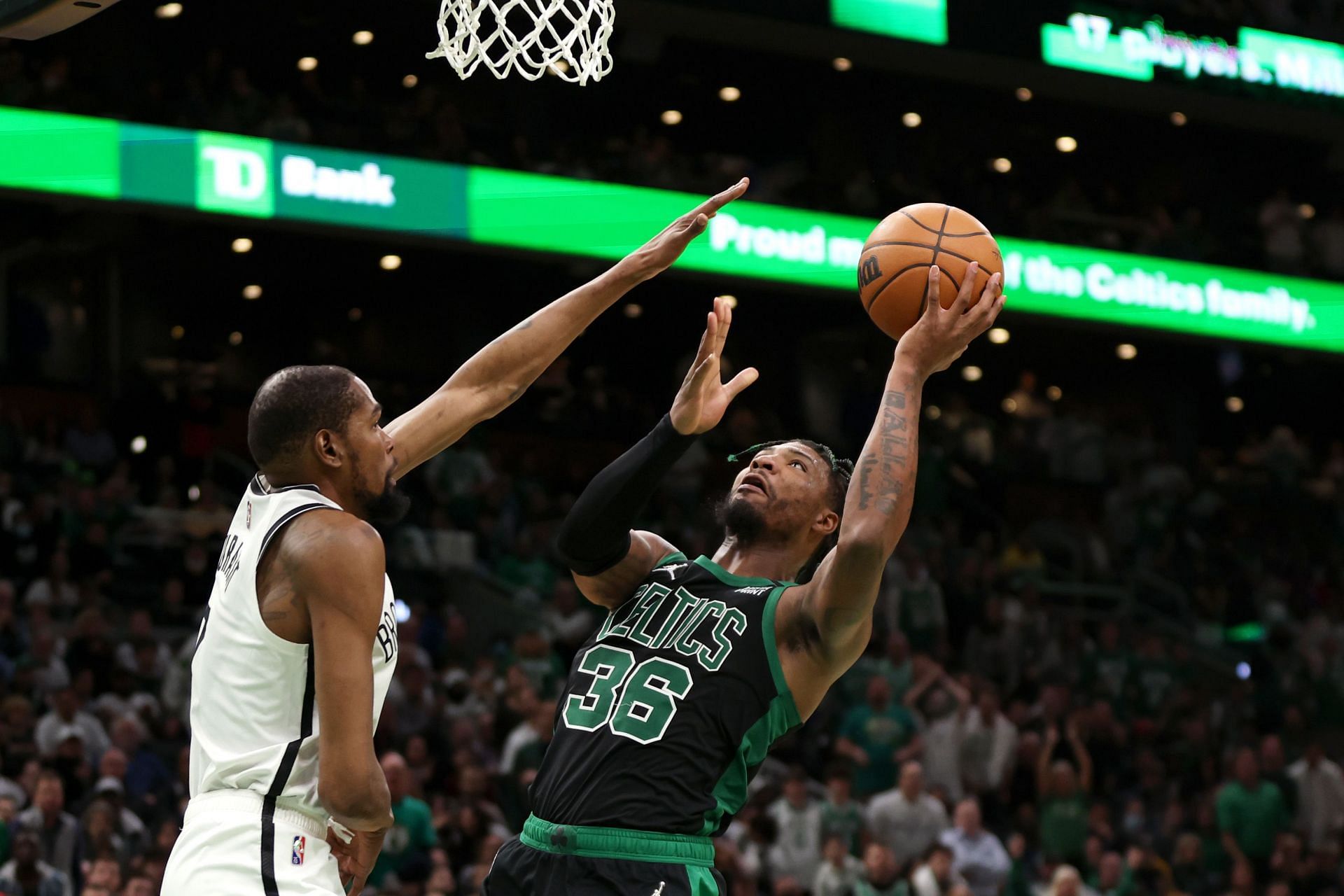 Kevin Durant of the Brooklyn Nets guards Marcus Smart of the Boston Celtics.