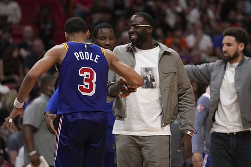 Jordan Poole of the Golden State Warriors is congratulated by Draymond Green