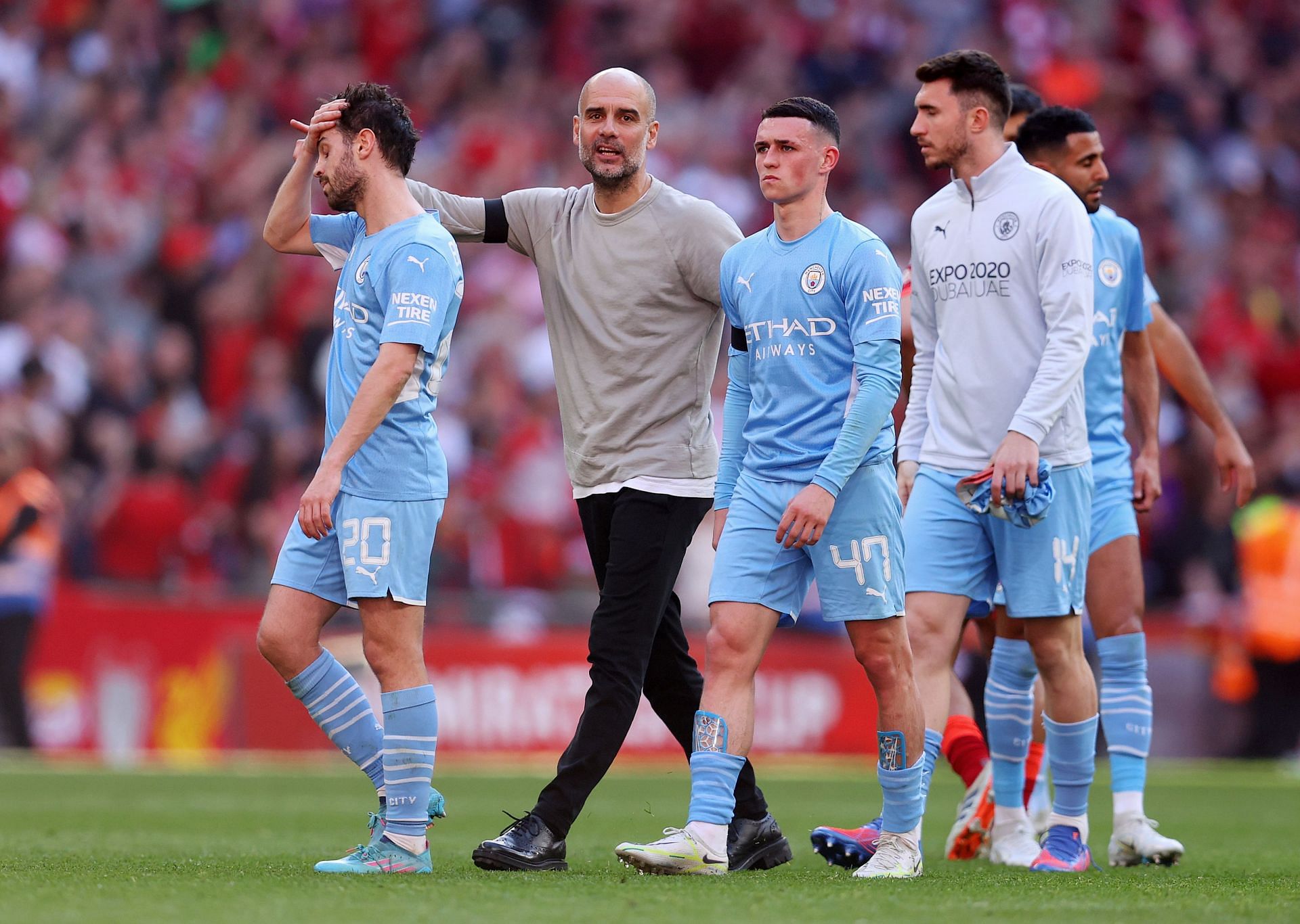 Pep Guardiola consoles his players after the loss.