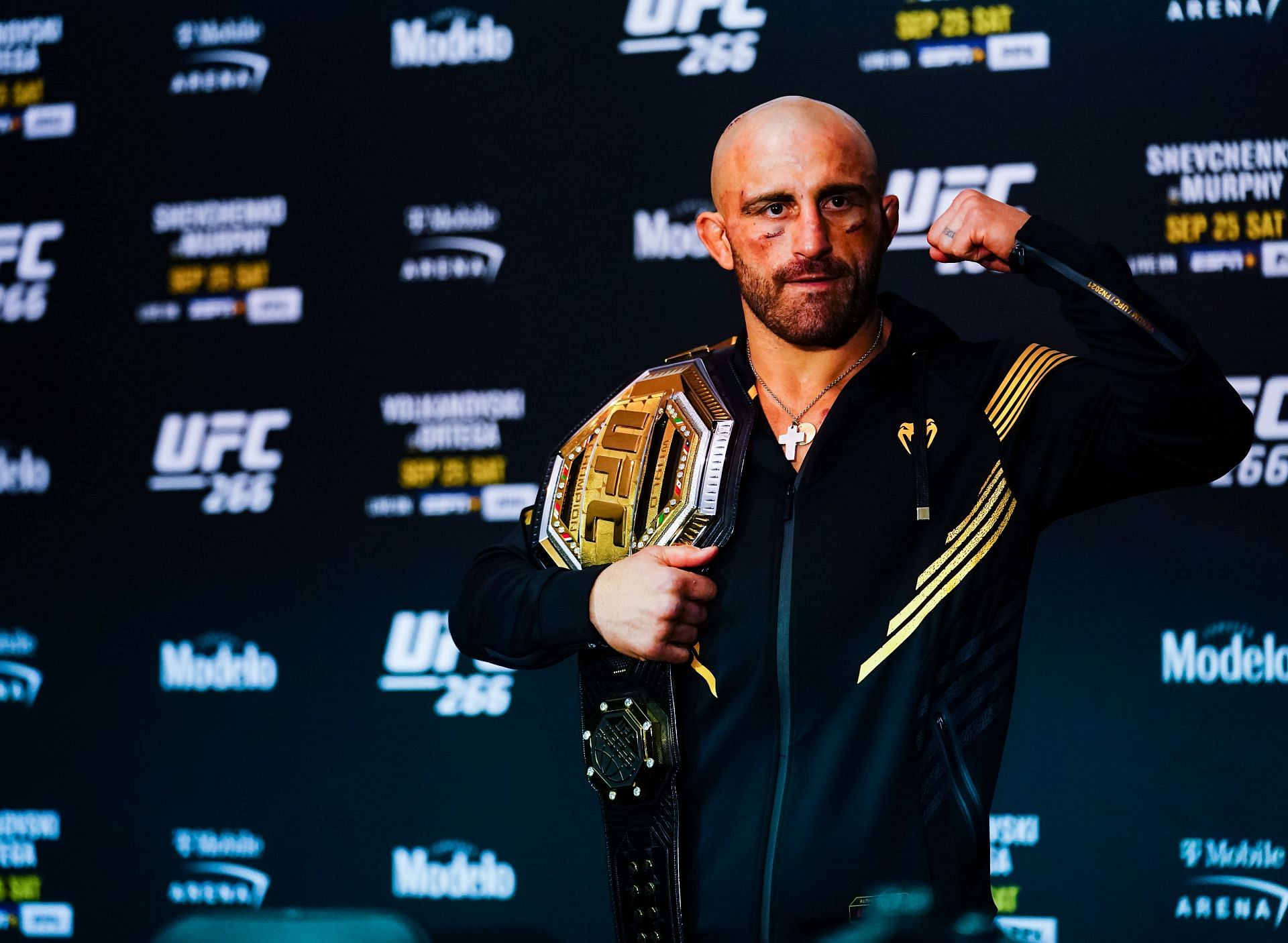 Alexander Volkanovski posing with championship belt