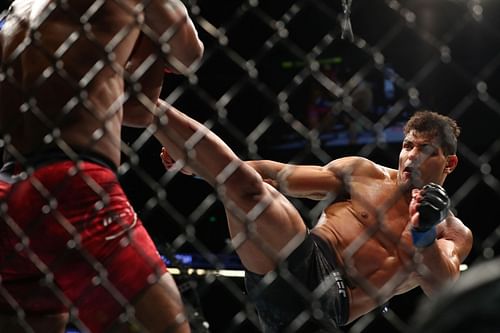 Paulo Costa lands a kick on Yoel Romero