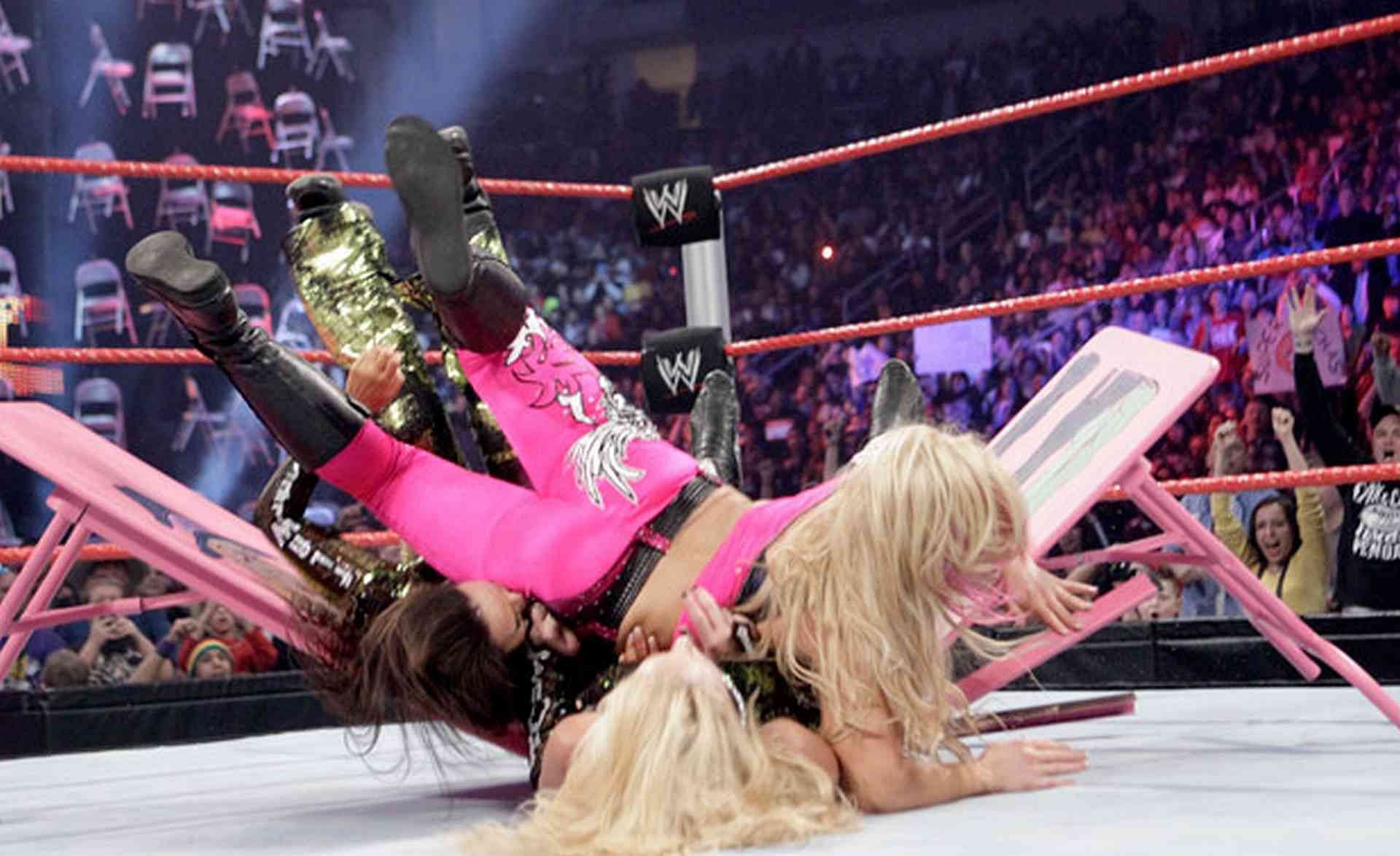 Natalya putting McCool and Layla through a table.
