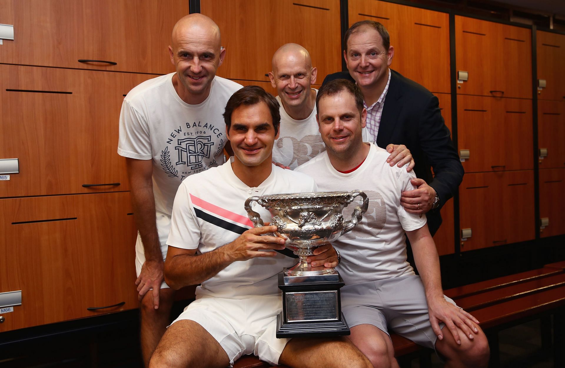 Roger Federer with Tony Godsick (far right) and the rest of his team after his 20th Major title