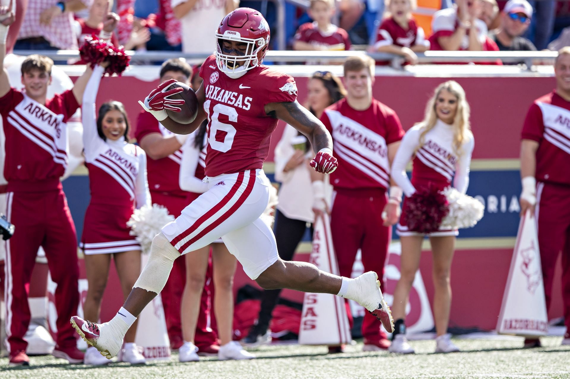 Treylon Burks #16 of the Arkansas Razorbacks runs the ball in for a touchdown in the first half of a game against the Arkansas-Pine Bluff Golden Lions at War Memorial Stadium on October 23, 2021 in Little Rock, Arkansas.