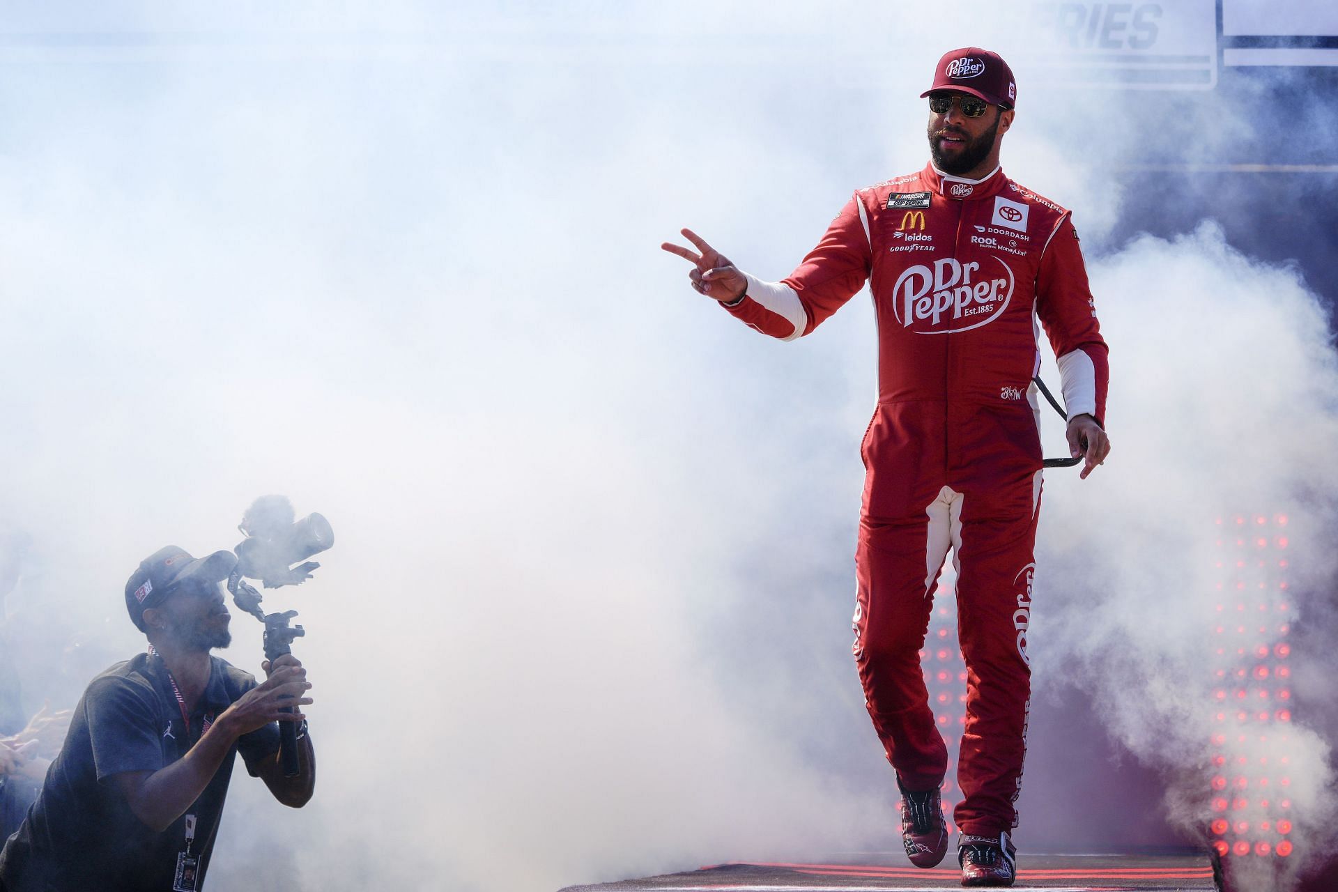 Bubba Wallace Jr. waves to fans onstage during driver intros prior to the NASCAR Cup Series Toyota Owners 400 at Richmond Raceway. (Photo by Jacob Kupferman/Getty Images)