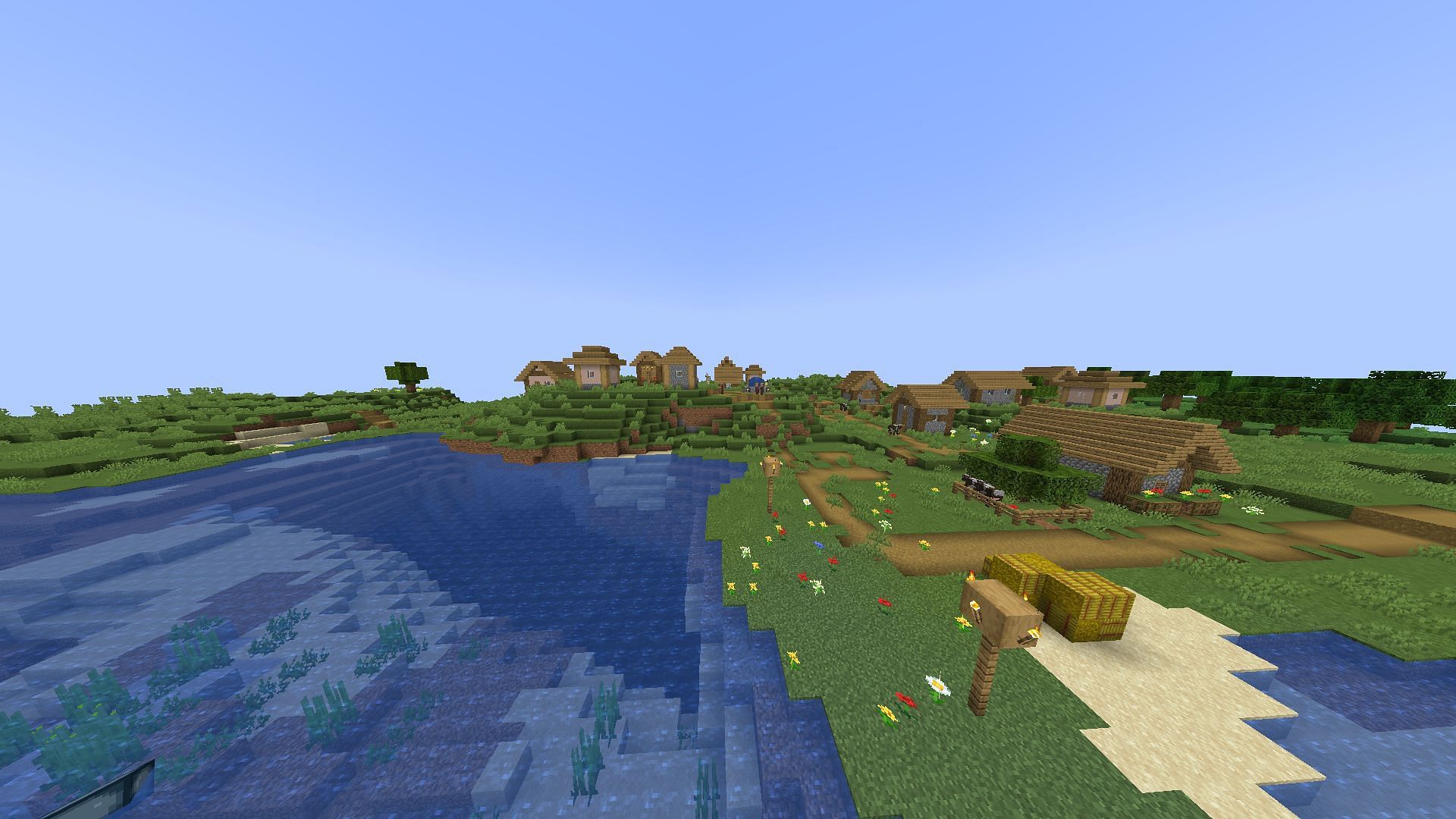 A village near a lake (Image via Minecraft)