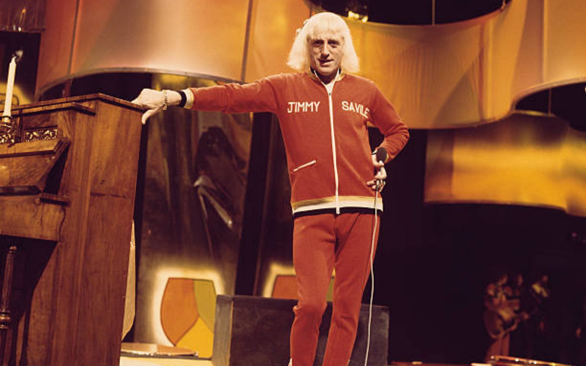 Savile presenting the BBC music chart show Top Of The Pops in 1973 (Image via Michael Putland/Getty Images)