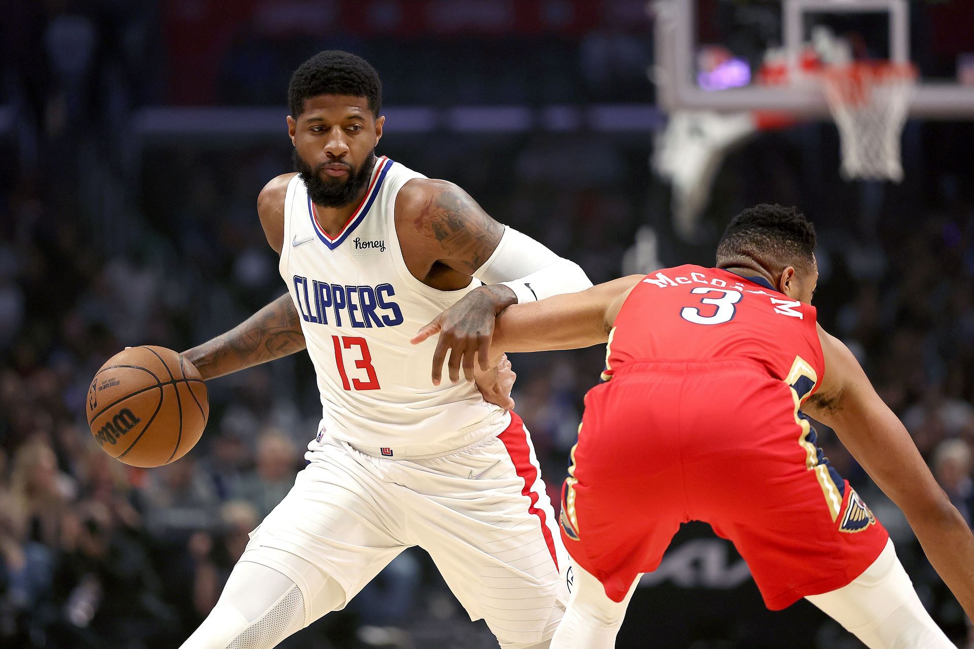 Paul George dribbling past CJ McCollum