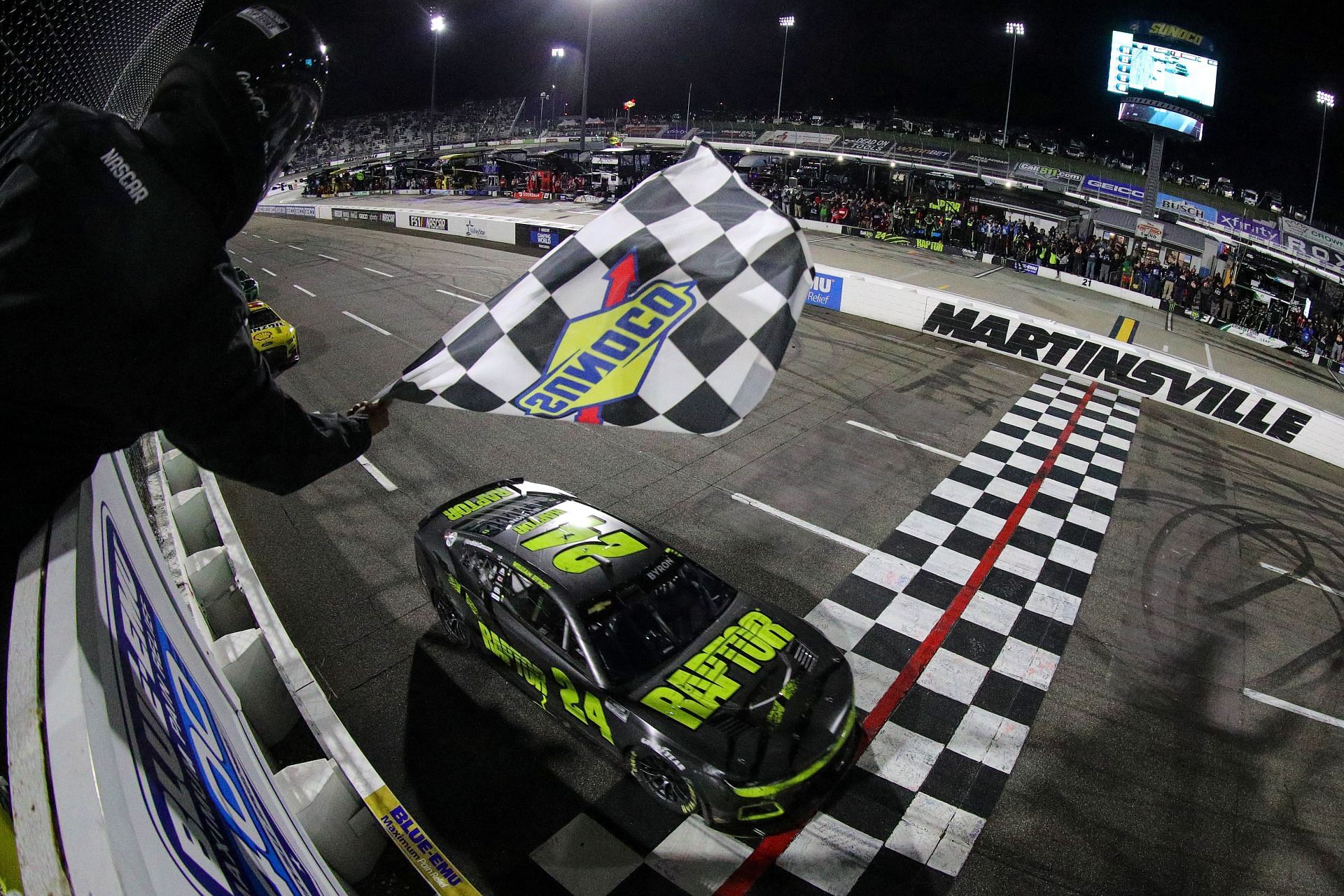 William Byron takes the checkered flag to win the NASCAR Cup Series Blue-Emu Maximum Pain Relief 400 at Martinsville Speedway (Photo by Meg Oliphant/Getty Images)