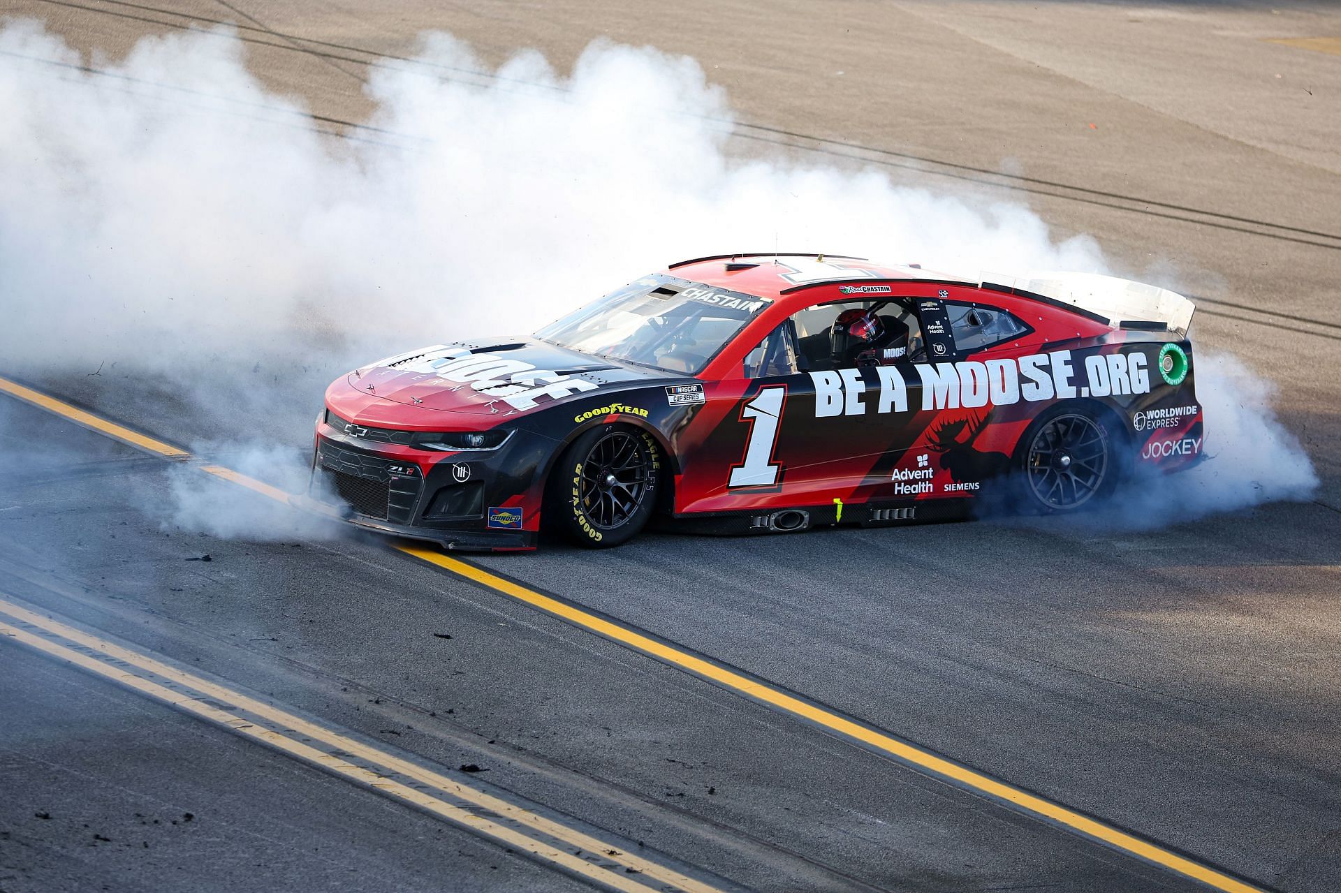 Ross Chastain celebrates with a burnout after winning the NASCAR Cup Series GEICO 500 at Talladega Superspeedway. (Photo by James Gilbert/Getty Images)