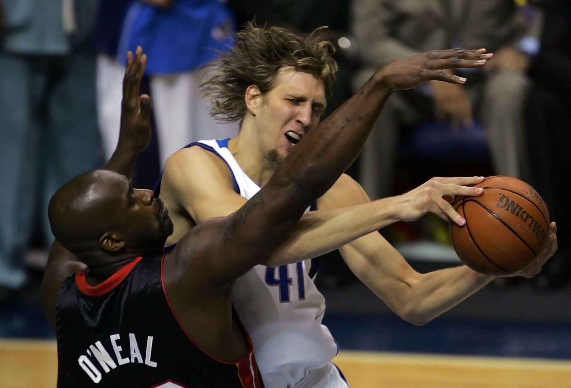 Dirk Nowitzki #41 of the Dallas Mavericks goes up for a shot over Shaquille O'Neal #32 of the Miami Heat