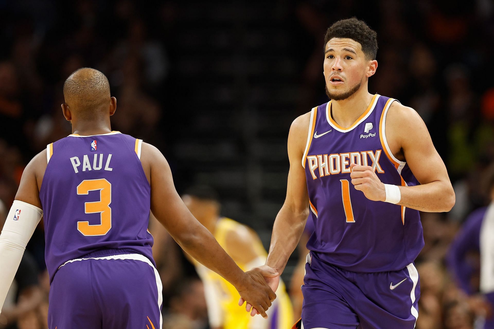Chris Paul and Devin Booker celebrate a play.