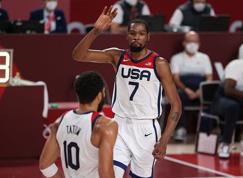 Kevin Durant (7) of Team USA high-fives teammate Jayson Tatum during the men's basketball final with Team France at the Olympics on Aug. 7, 2021, in Saitama, Japan.