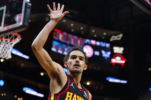 Trae Young No. 11 of the Atlanta Hawks reacts after scoring during the second half against the Charlotte Hornets at State Farm Arena on April 13, 2022 in Atlanta, Georgia.