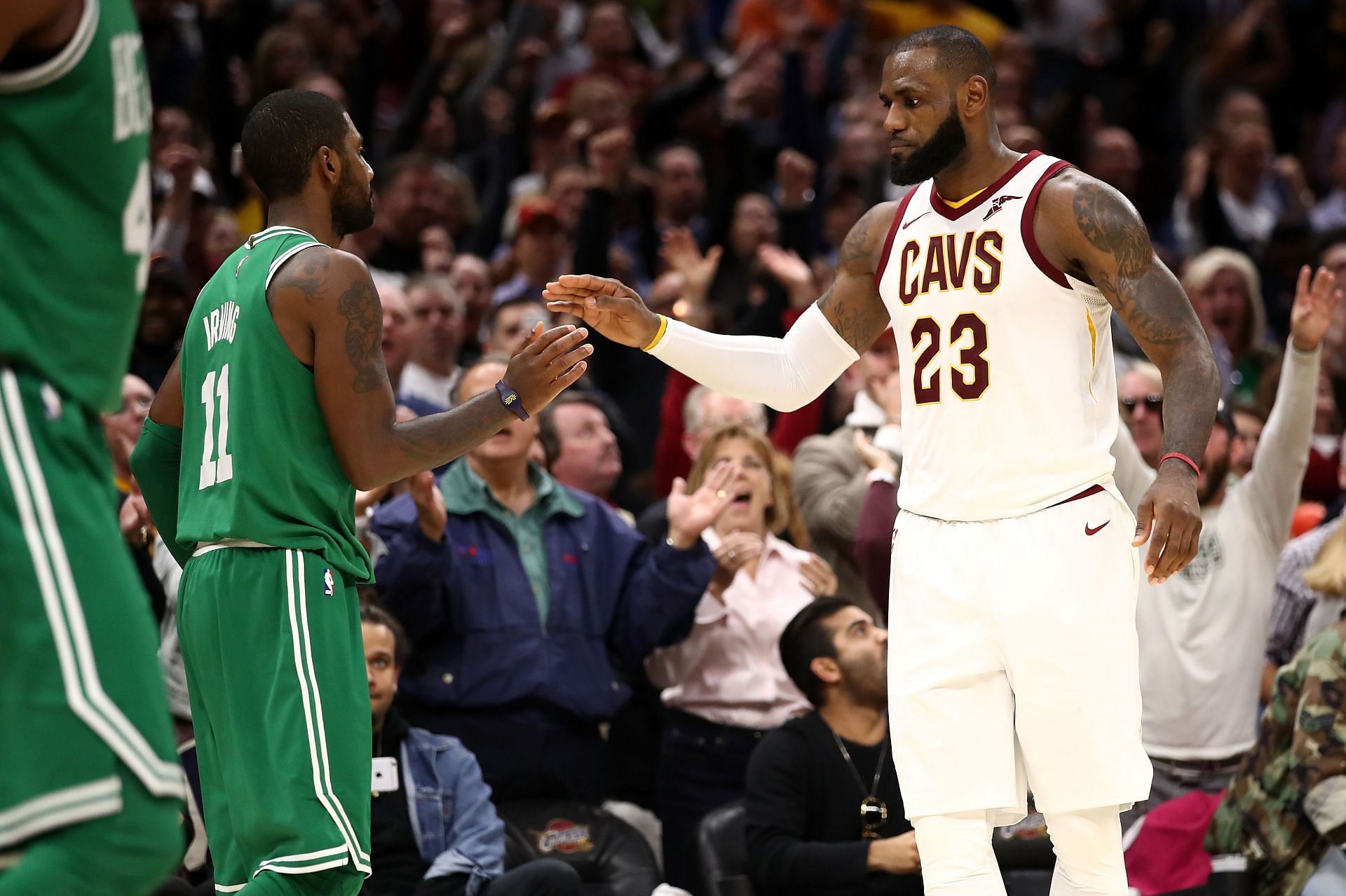 Kyrie Irving and LeBron James greet each other during an NBA game in 2018