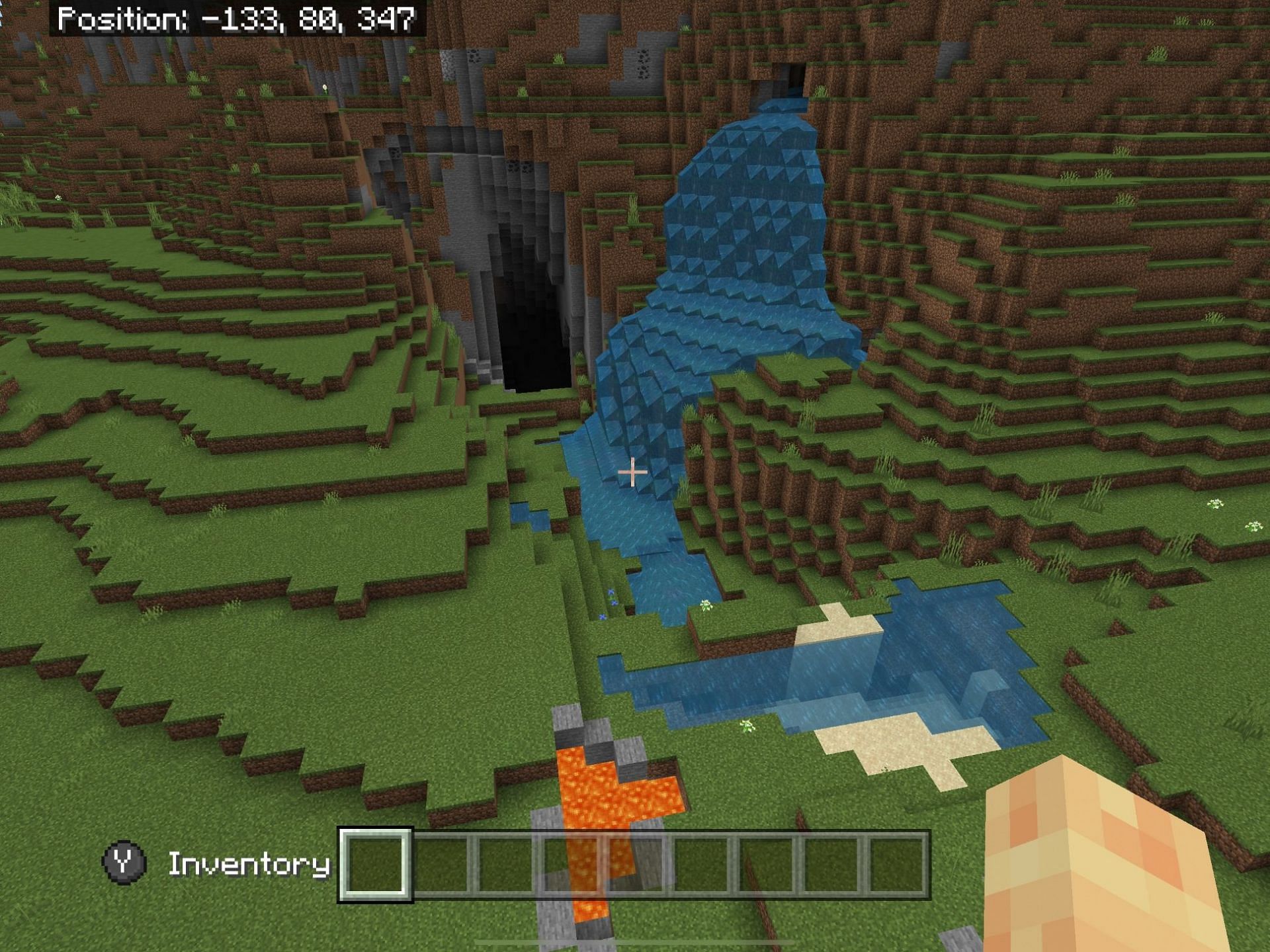 This strange-looking waterfall and cave combination is a great place to start an adventure (Image via Minecraft)
