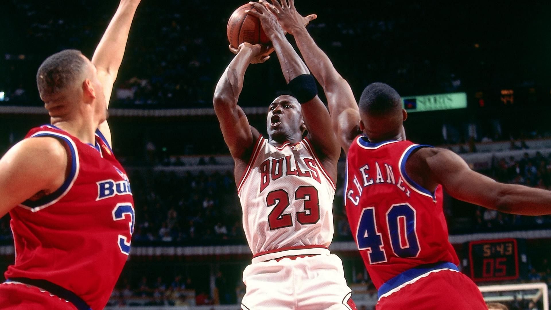 Michael Jordan shooting over two Washington Bullets players. (Photo: Sporting News)