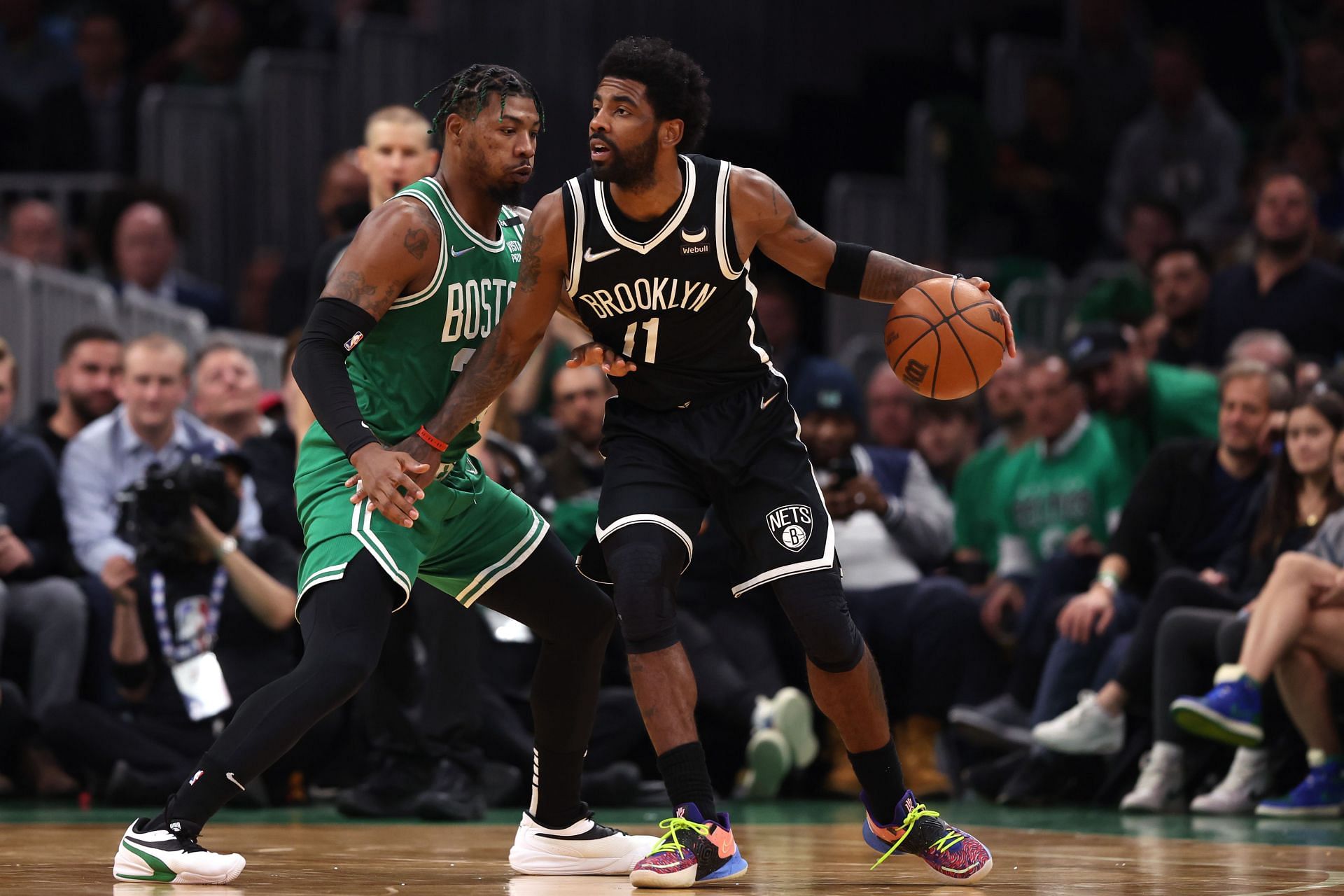 Kyrie Irving being guarded by Marcus Smart