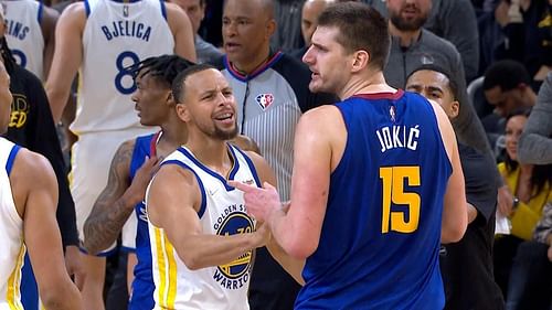 Golden State Warriors' Steph Curry tries to stop Nikola Jokic of the Denver Nuggets in Game 2