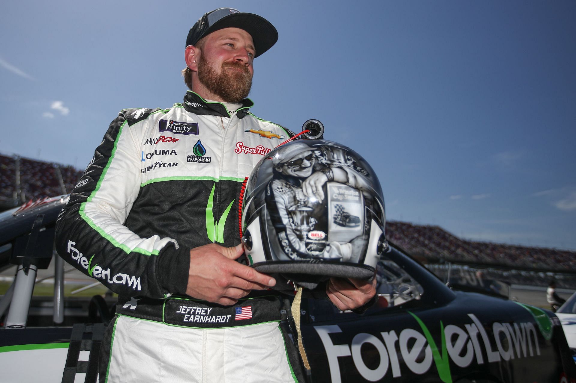Jeffrey Earnhardt displaying his helmet with an artist rendering of his grandfather Dale Earnhardt Sr. on the grid prior to the NASCAR Xfinity Series Ag-Pro 300 at Talladega Superspeedway.
