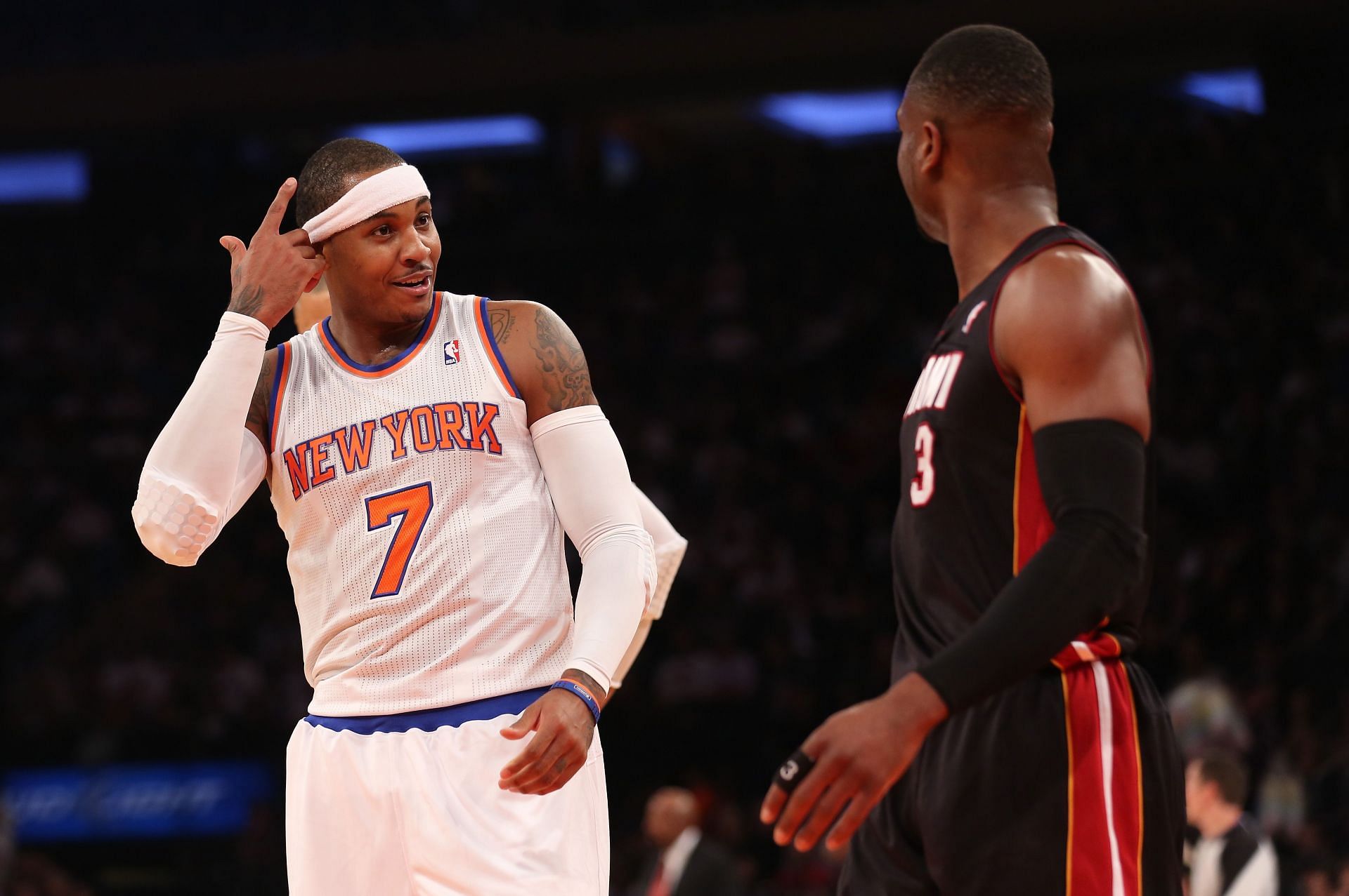 Carmelo Anthony of the New York Knicks gestures to Dwyane Wade of the Miami Heat