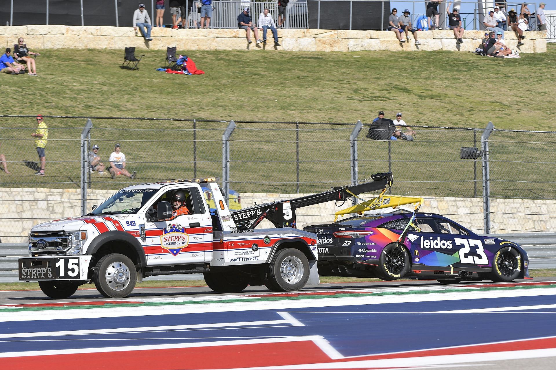 Bubba Wallace Jr.&#039;s Toyota Camry being towed during the 2022 NASCAR Cup Series Echopark Automotive Texas Grand Prix at Circuit of the Americas in Austin (Photo by Logan Riely/Getty Images)