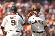 Darin Ruff congradulated teammate Brandon Belt after his eighth inning home run. Miami Marlins v Giants