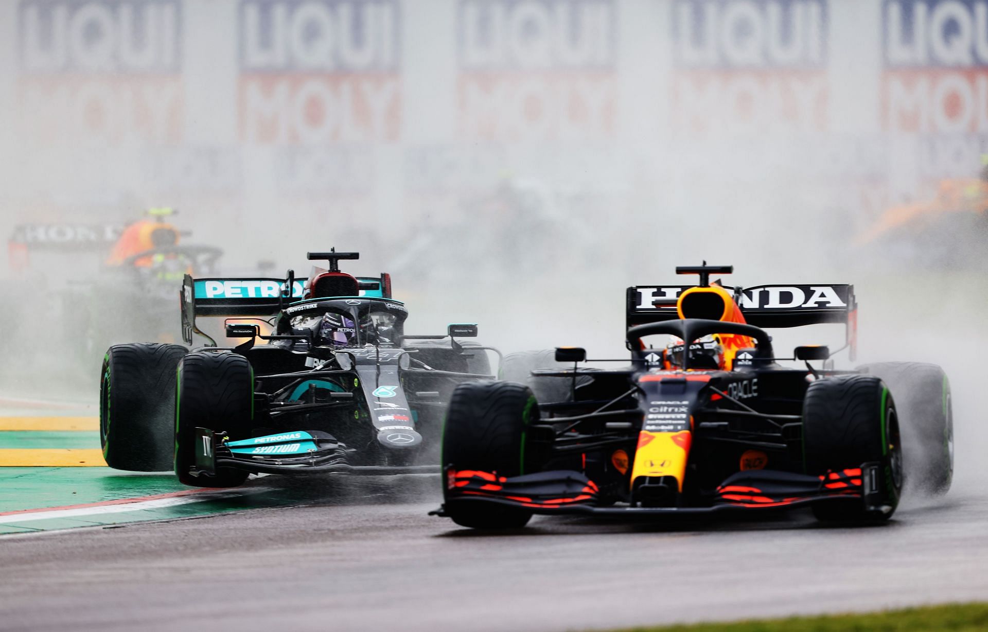 Lewis Hamilton (left) rides the kerb at Turn 1 to avoid colliding into Max Verstappen (right) at the 2021 Imola GP (Photo by Bryn Lennon/Getty Images)