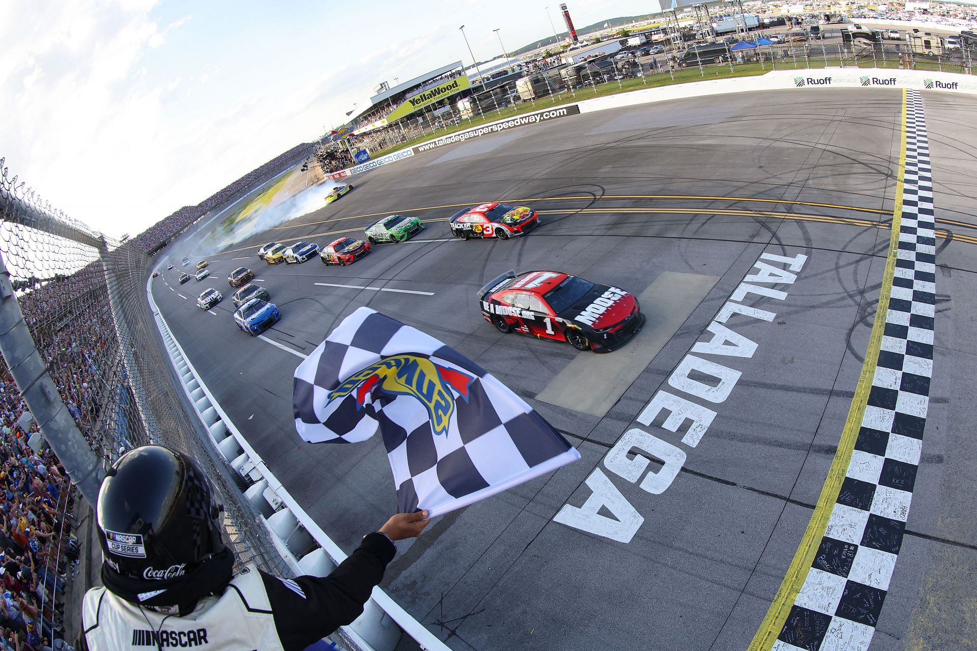 Ross Chastain takes the checkered flag to win the NASCAR Cup Series GEICO 500 at Talladega Superspeedway (Photo by James Gilbert/Getty Images)