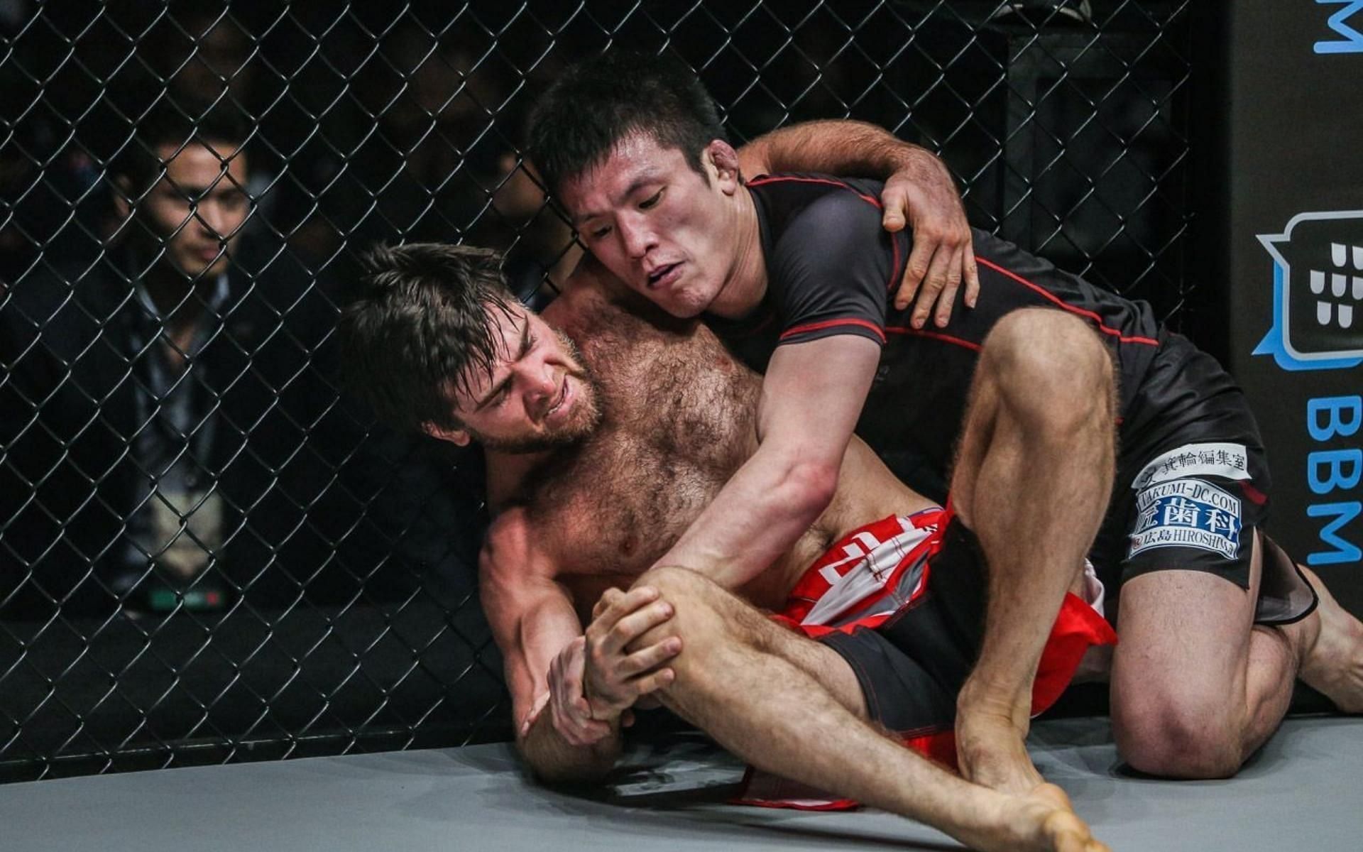 Former ONE featherweight champion Marat Gafurov (left) engaged in a submission grappling match against former ONE lightweight champ Shinya Aoki (right) back in 2018. (Image courtesy of ONE Championship)