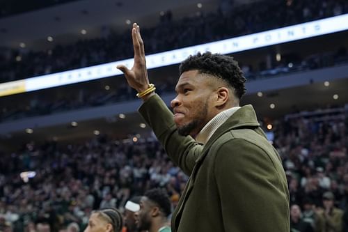 Giannis Antetokounmpo of the Milwaukee Bucks waves to the crowd as he is honored for passing Kareem Abdul-Jabbar's Bucks franchise mark of 14,211 points during a stoppage in play in the first half against the LA Clippers at Fiserv Forum on Friday in Milwaukee, Wisconsin.