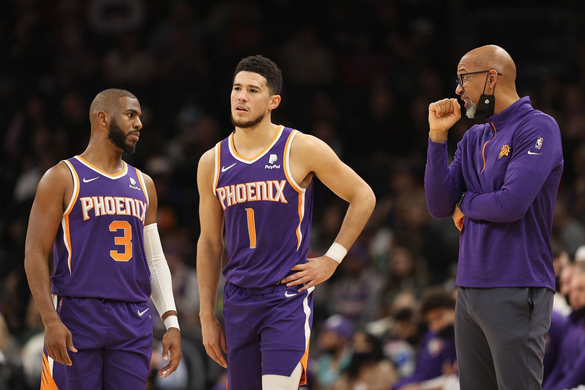 Head coach Monty Williams of the Phoenix Suns talks with Chris Paul and Devin Booker