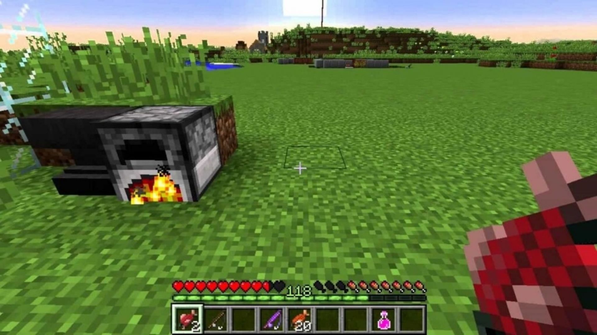 A player cooks salmon in a nearby furnace (Image via Mojang)
