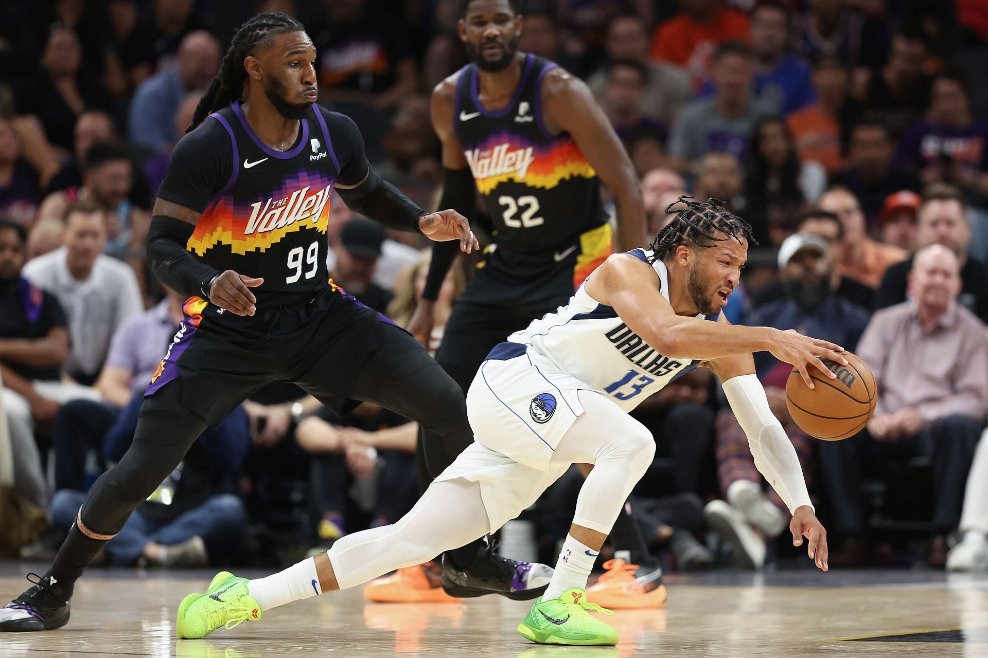 Jalen Brunson of the Dallas Mavericks attempts to control the ball after a foul from Jae Crowder.