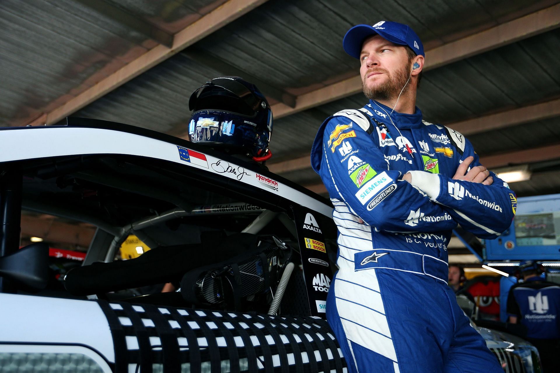 Dale Earnhardt Jr. stands in the garage area during practice for the 2017 Monster Energy NASCAR Cup Series Apache Warrior 400 presented by Lucas Oil at Dover International Speedway in Dover, Delaware (Photo by Sean Gardner/Getty Images)